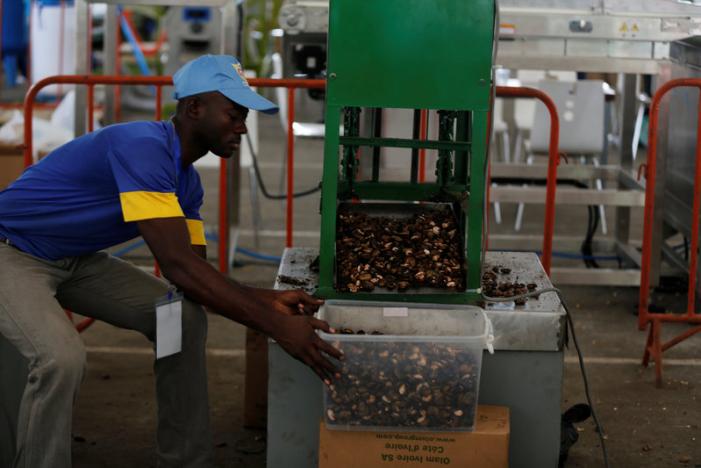 A man works on a machine during SIETTA 2016, the International Exhibition of Cashew-Processing Equipment and Technologies in culture palace at Abidjan